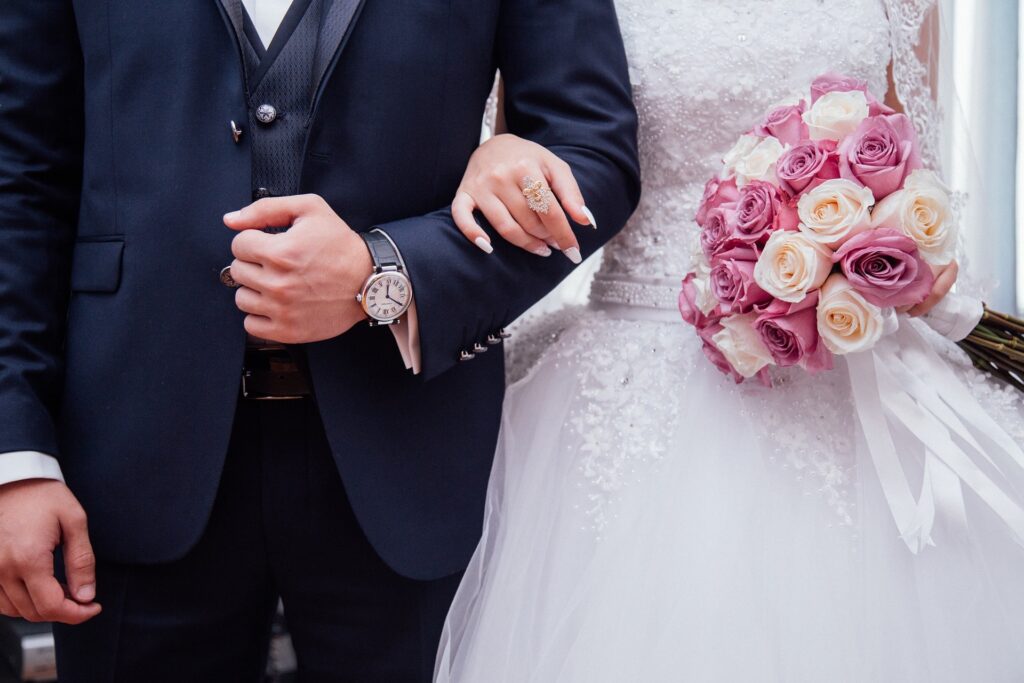 Bride and Groom Arm in Arm With Bouquet