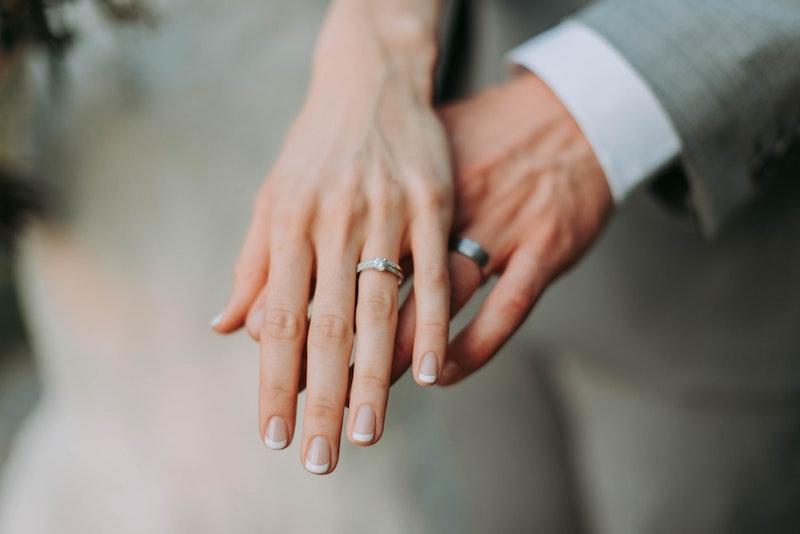 Two People Showing Wedding Rings on Their Fingers