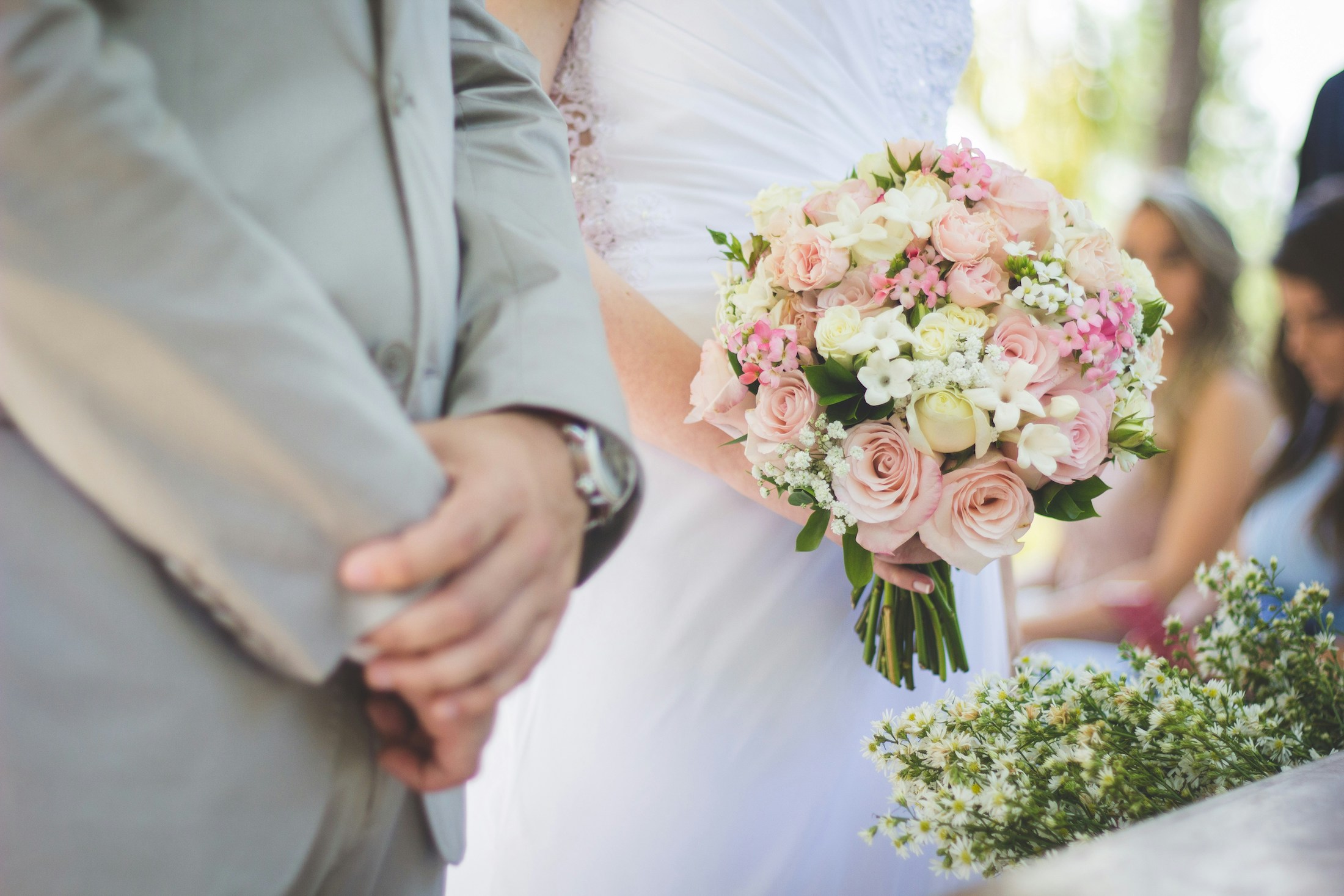 bride holding bouquet next to groom